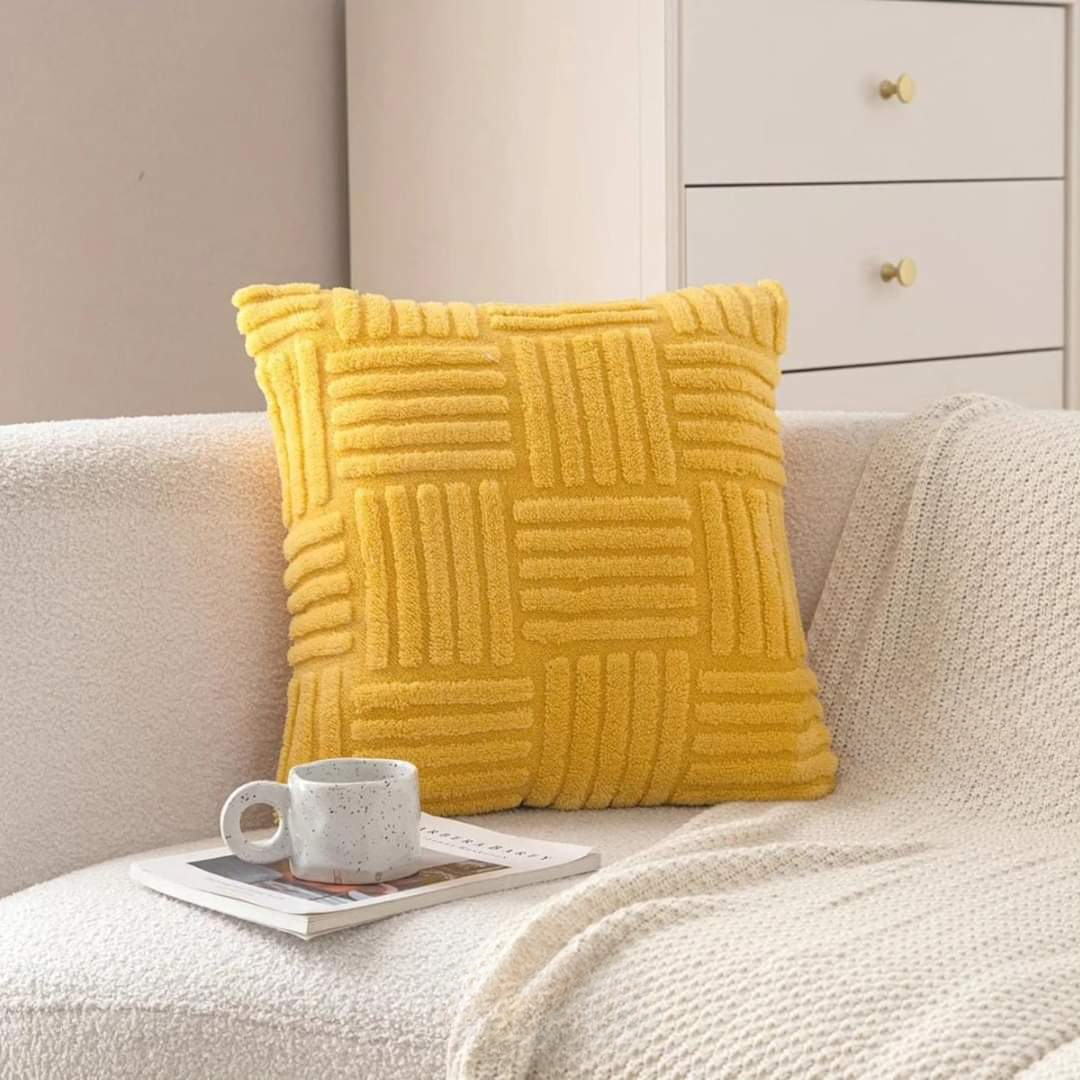 Yellow cover on a boucle sofa