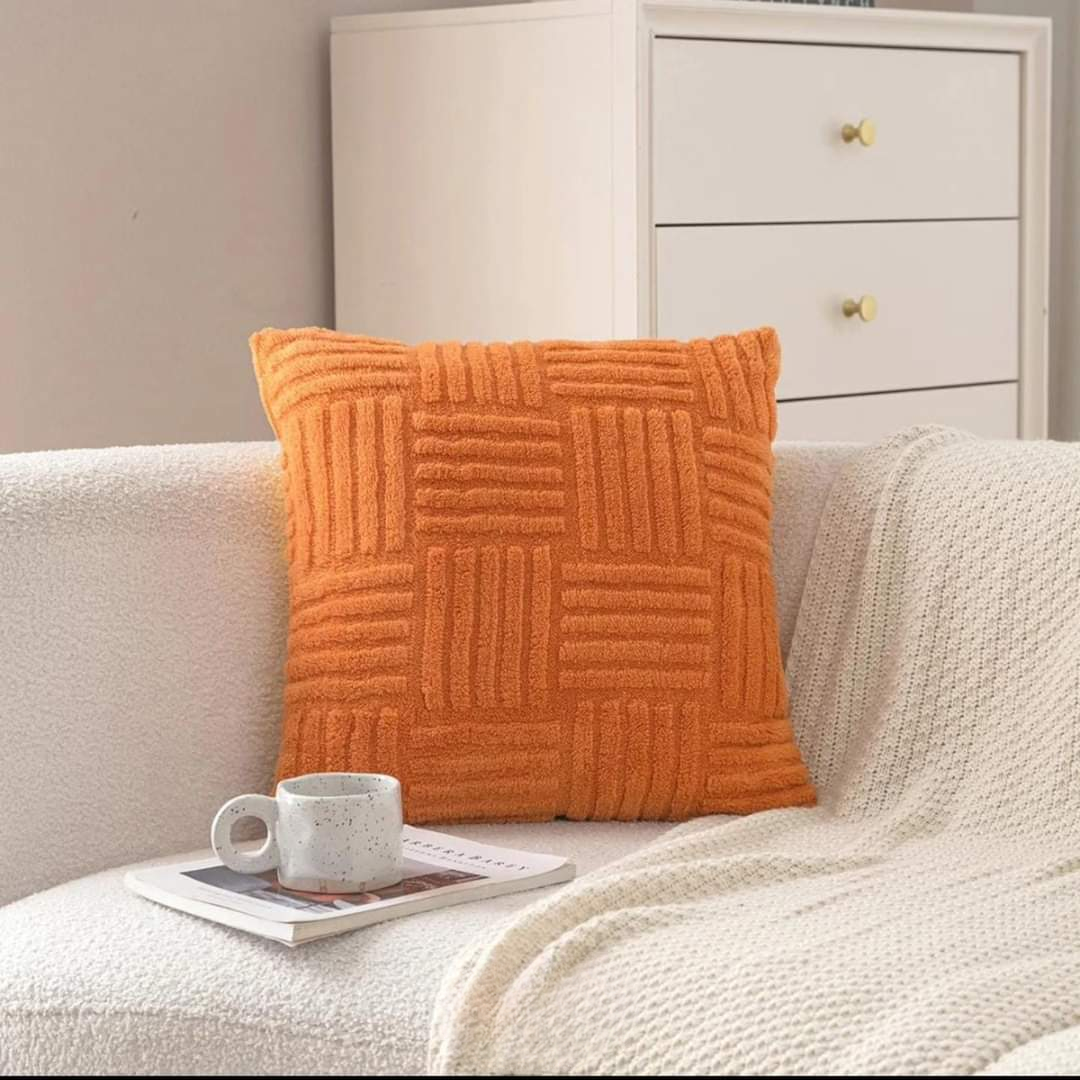 Orange cover on a boucle sofa