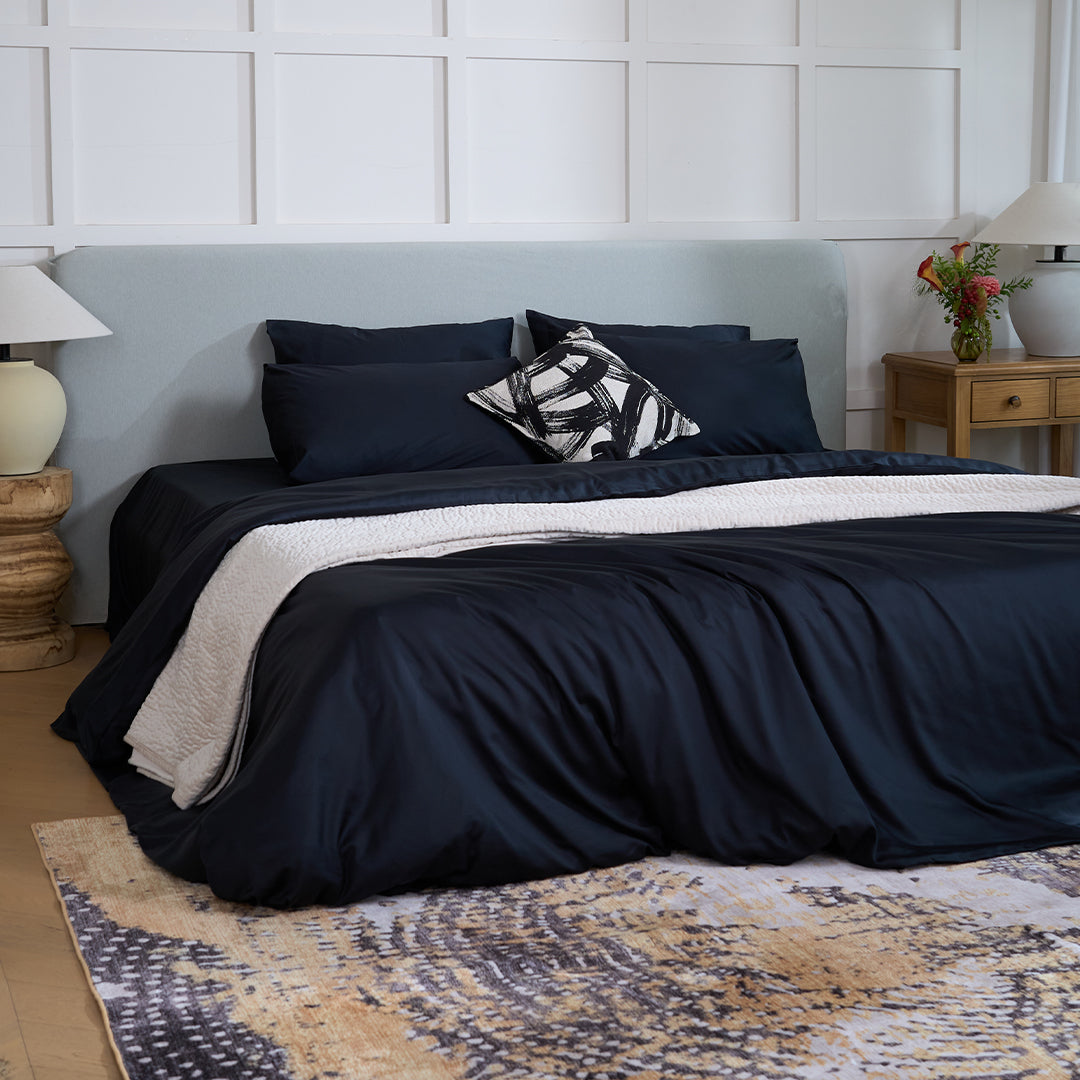 Navy bed against panelling